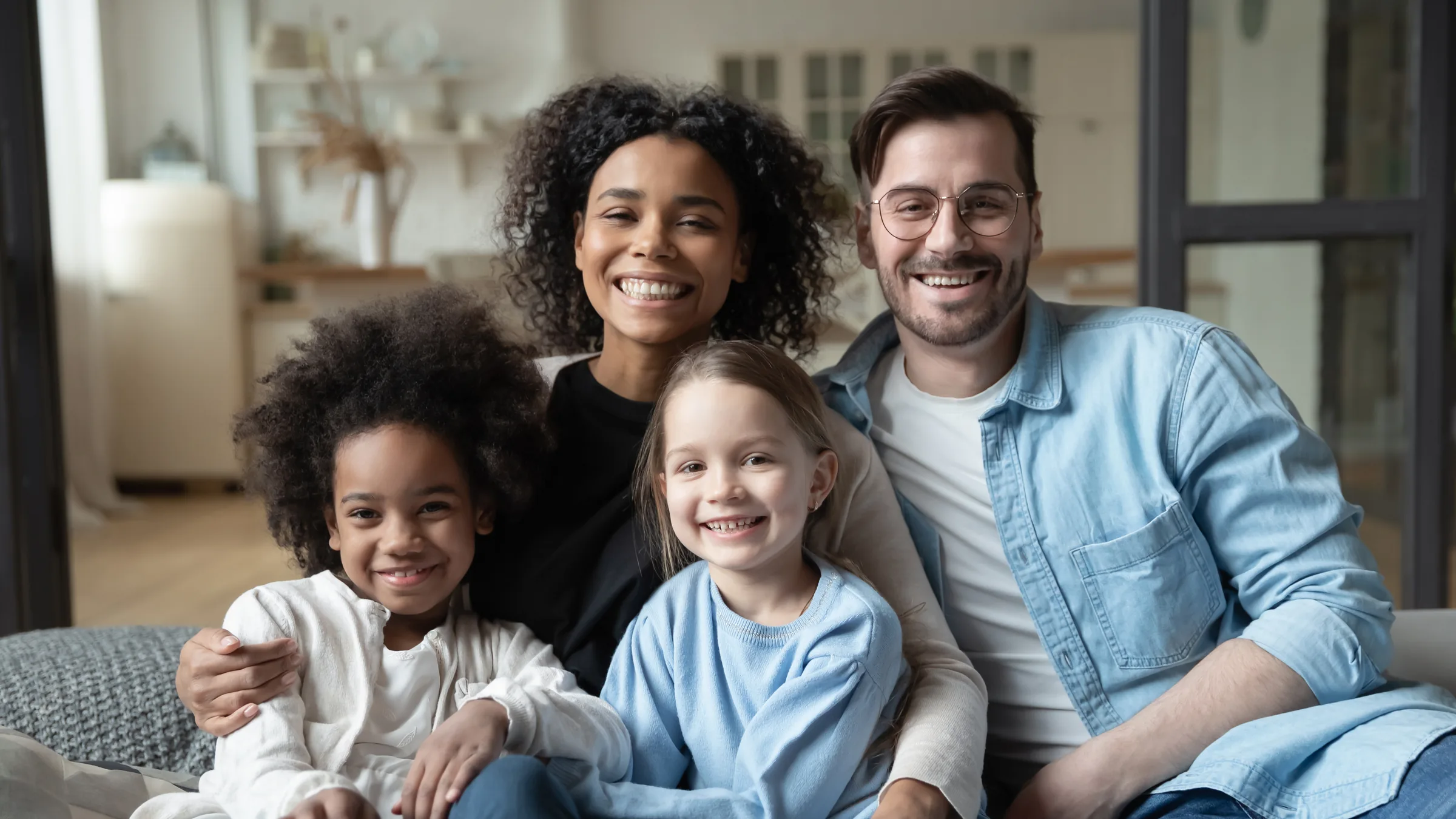 A smiling family sitting together at home