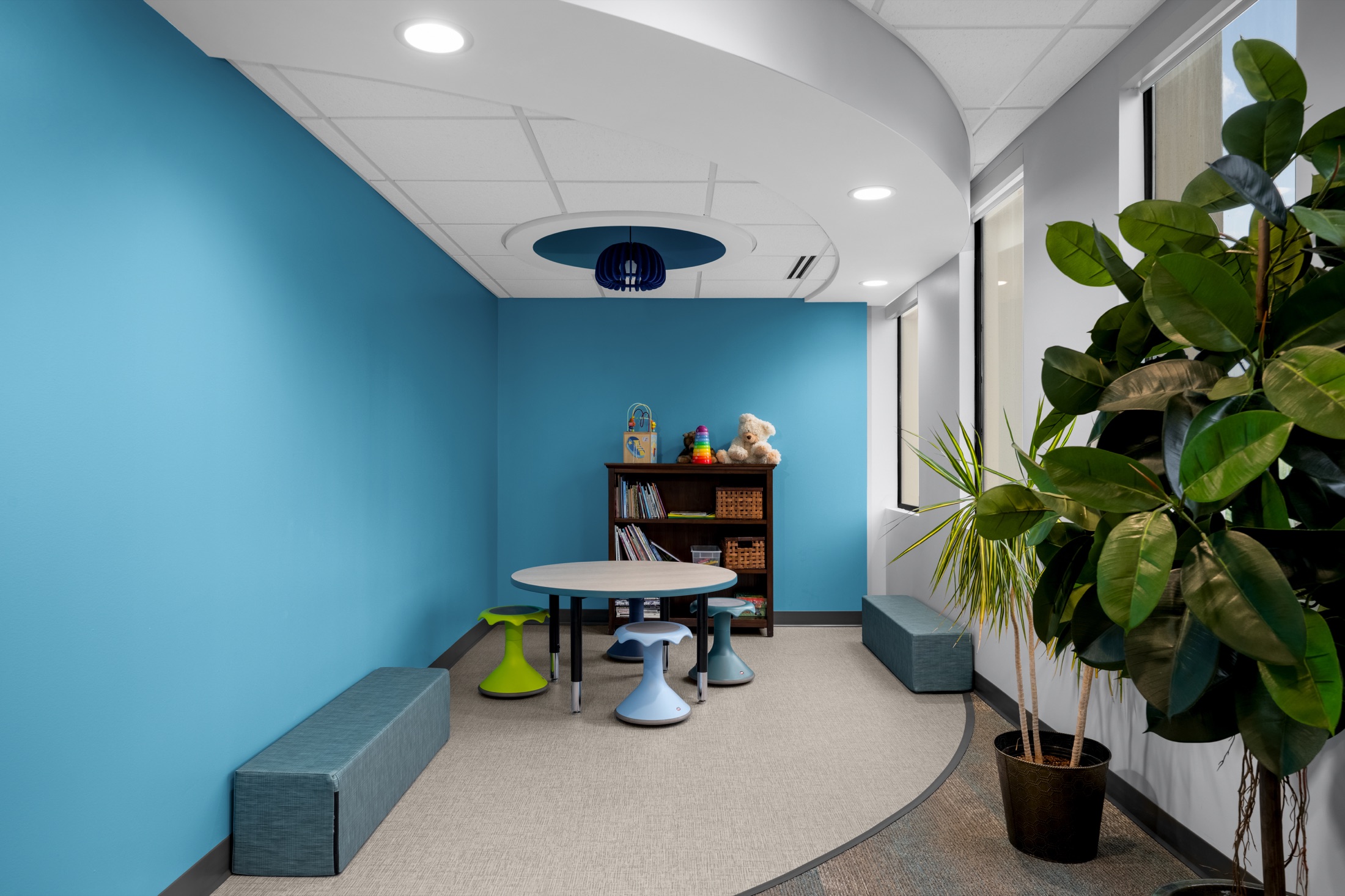 Children’s play area with books, toys, and colorful seating