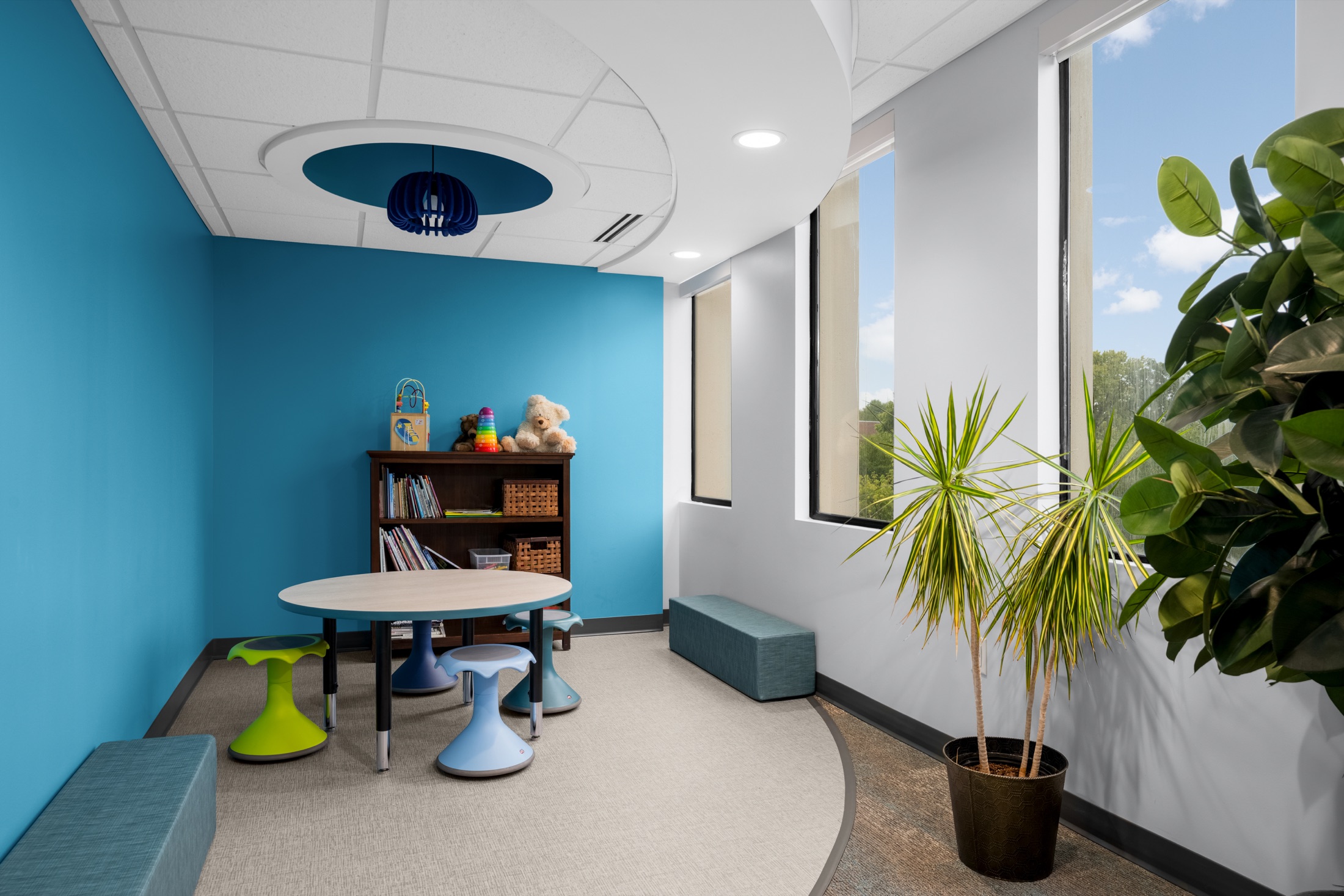 Children’s play area beside floor-to-ceiling windows