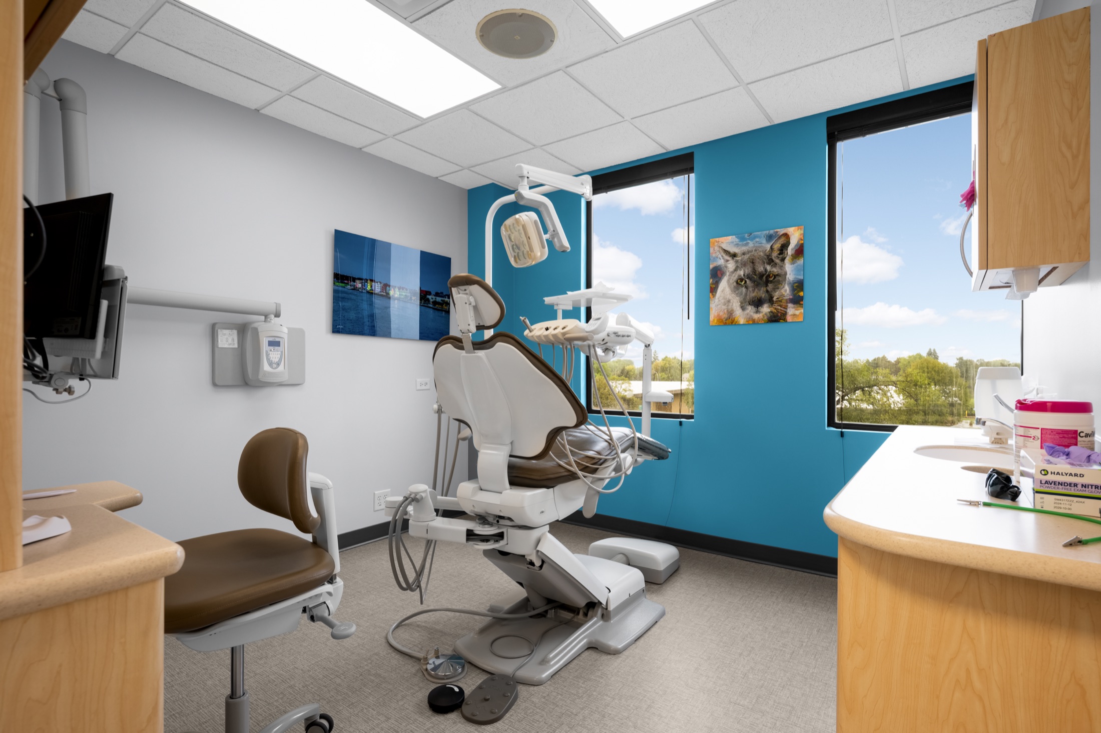 Modern dental operatory with a patient chair and digital equipment