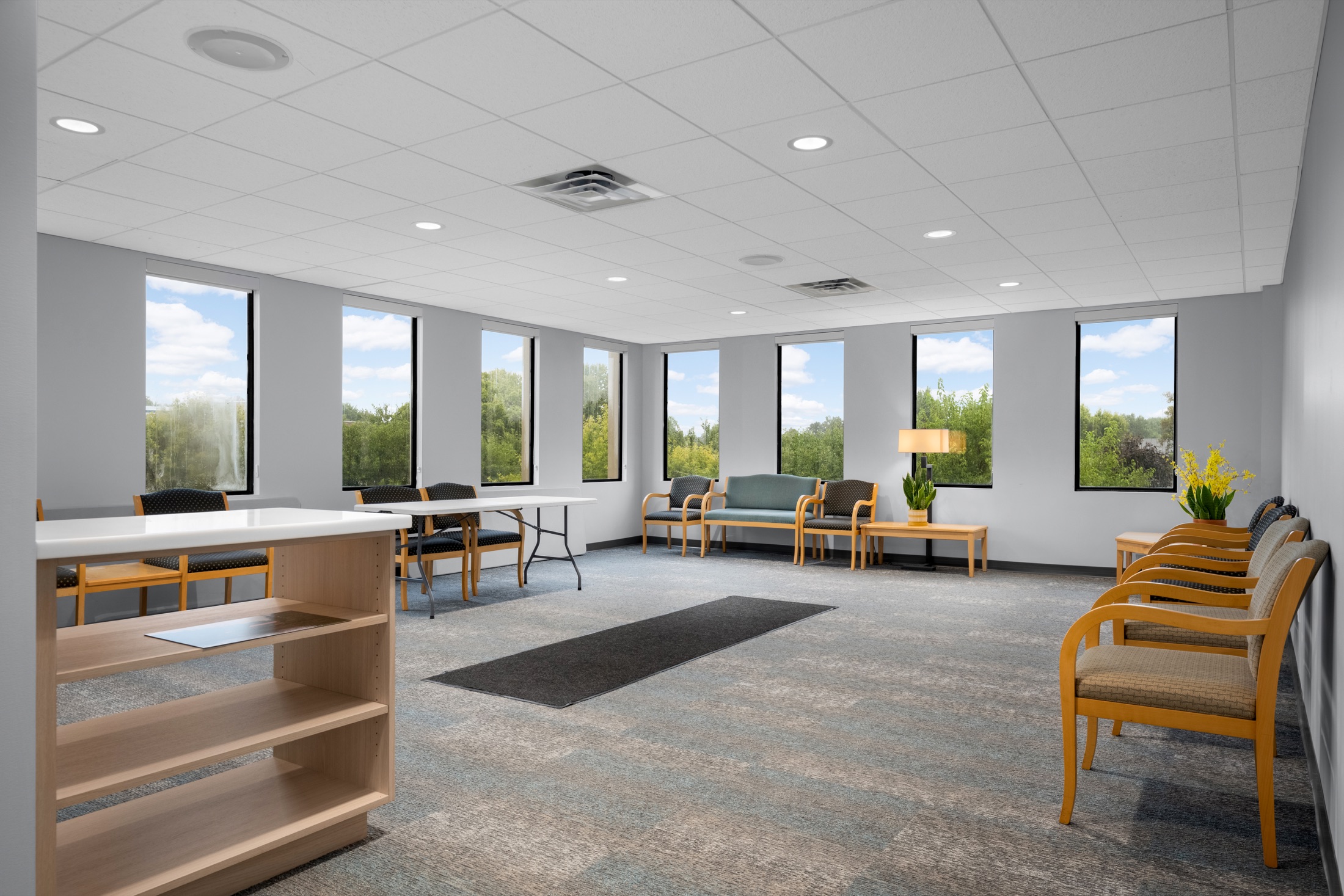 Spacious patient waiting room with large windows and comfortable seating